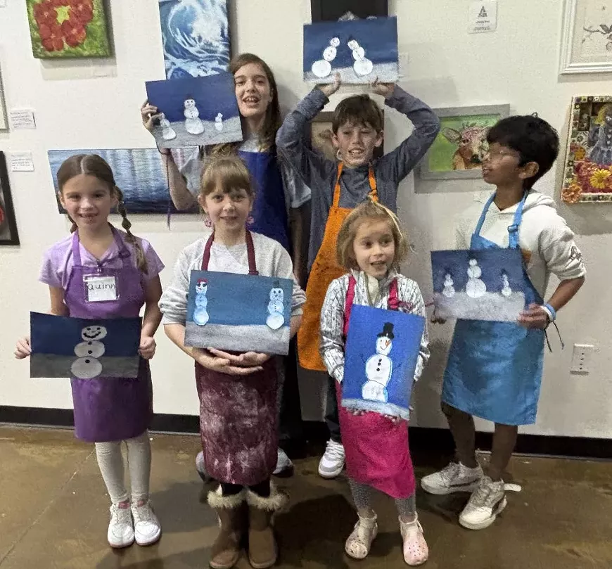 Campers show off their snowment artwork