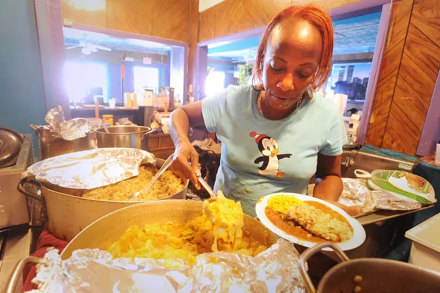 Lola Stephens provides Thanksgiving dinner to the homeless at her restaurant, Nubian Queen Lola's Cajun Kitchen, in 2009